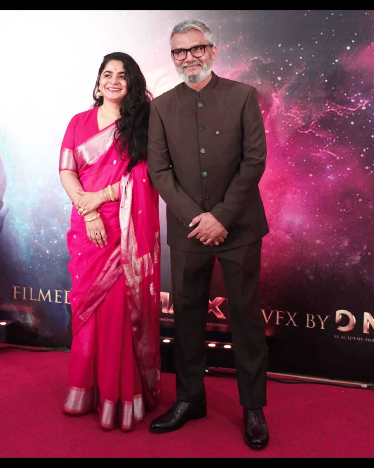 Director Nitesh Tiwari and wife Ashwiny Iyer Tiwari made a graceful appearance in coordinated traditional ensembles. Ashwiny looked elegant in a vibrant pink silk saree with silver borders, while Nitesh complemented her in a chocolate brown bandhgala suit.